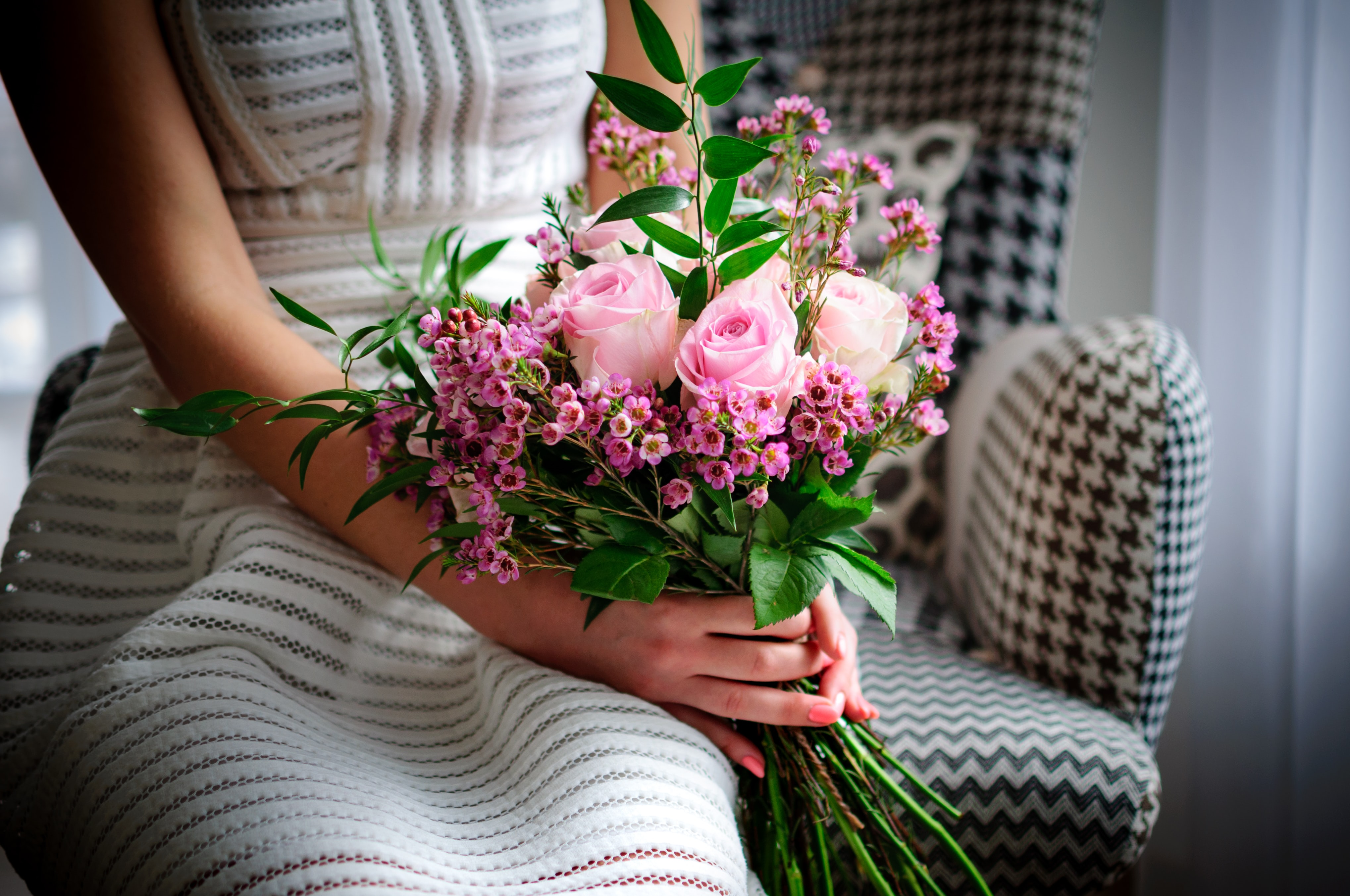 woman holds a bouquet of flowers