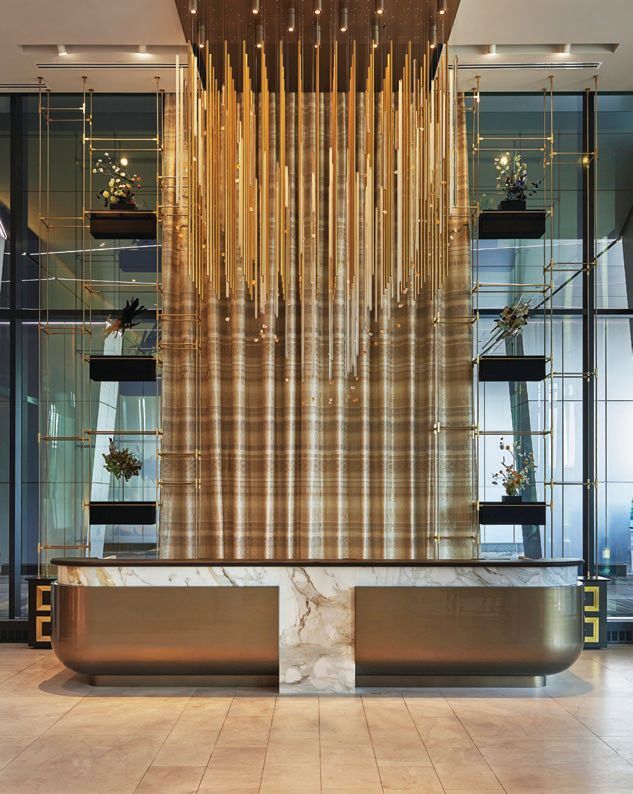 In the double-height lobby, a floating chandelier crafted with linear metal rods and glass orbs stars Photographed by Mike Schwartz
