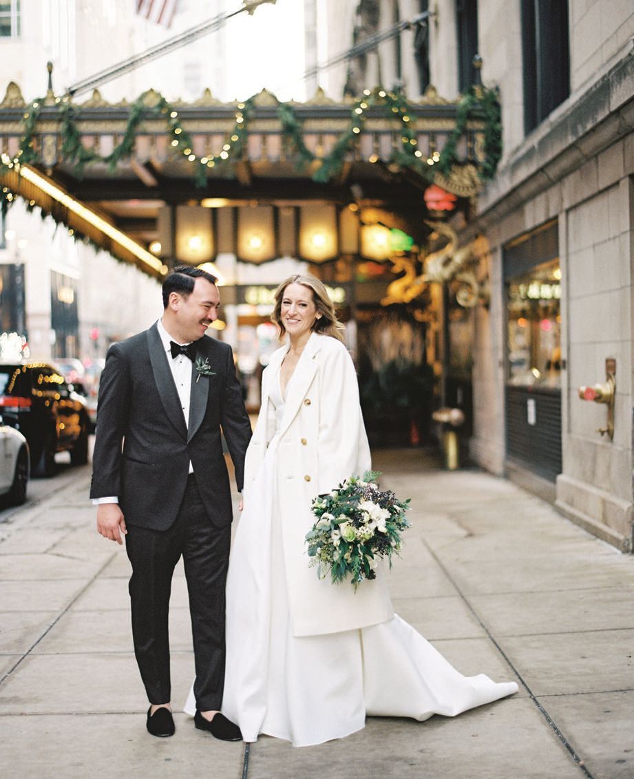 Bride Amy gave off sophisticated winter wedding vibes in a long ivory pea coat
worn over her gown
