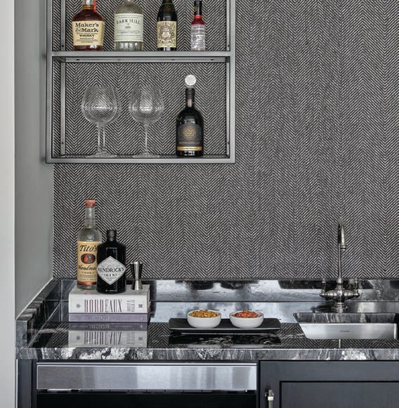A wet bar adjacent to the kitchen charms with a backsplash of honeycomb Nottingham tile in Veil by Ann Sacks PHOTOGRAPHED BY Gynthia Lynn