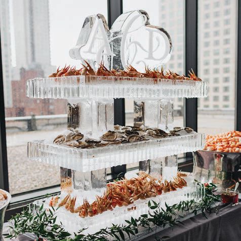 A custom seafood station was displayed on an ice sculpture bearing the couple’s wedding monogram