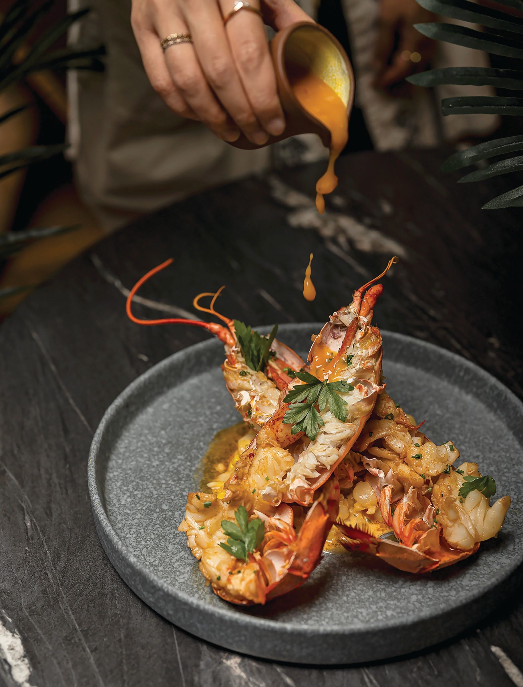 Indulgent Caribbean lobster is finished with creamed corn and passion fruit mojo. PHOTO BY WADE HALL
