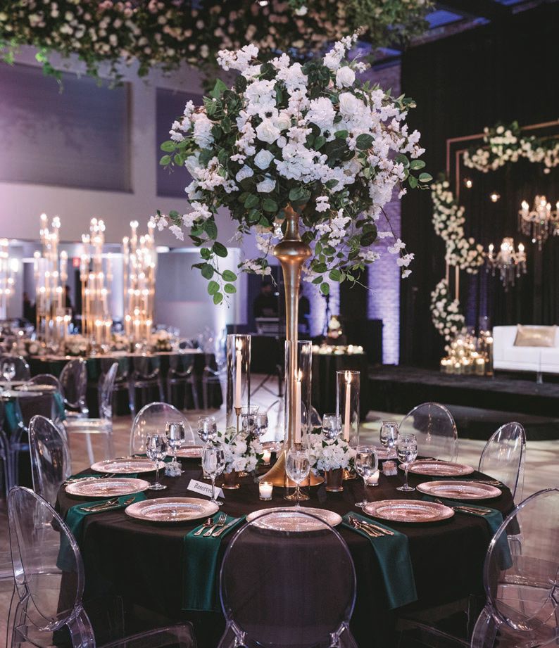 Decadent centerpieces featured a striking mix of white hydrangeas and roses complemented by delicate greenery Photographed by Zandbox Photo