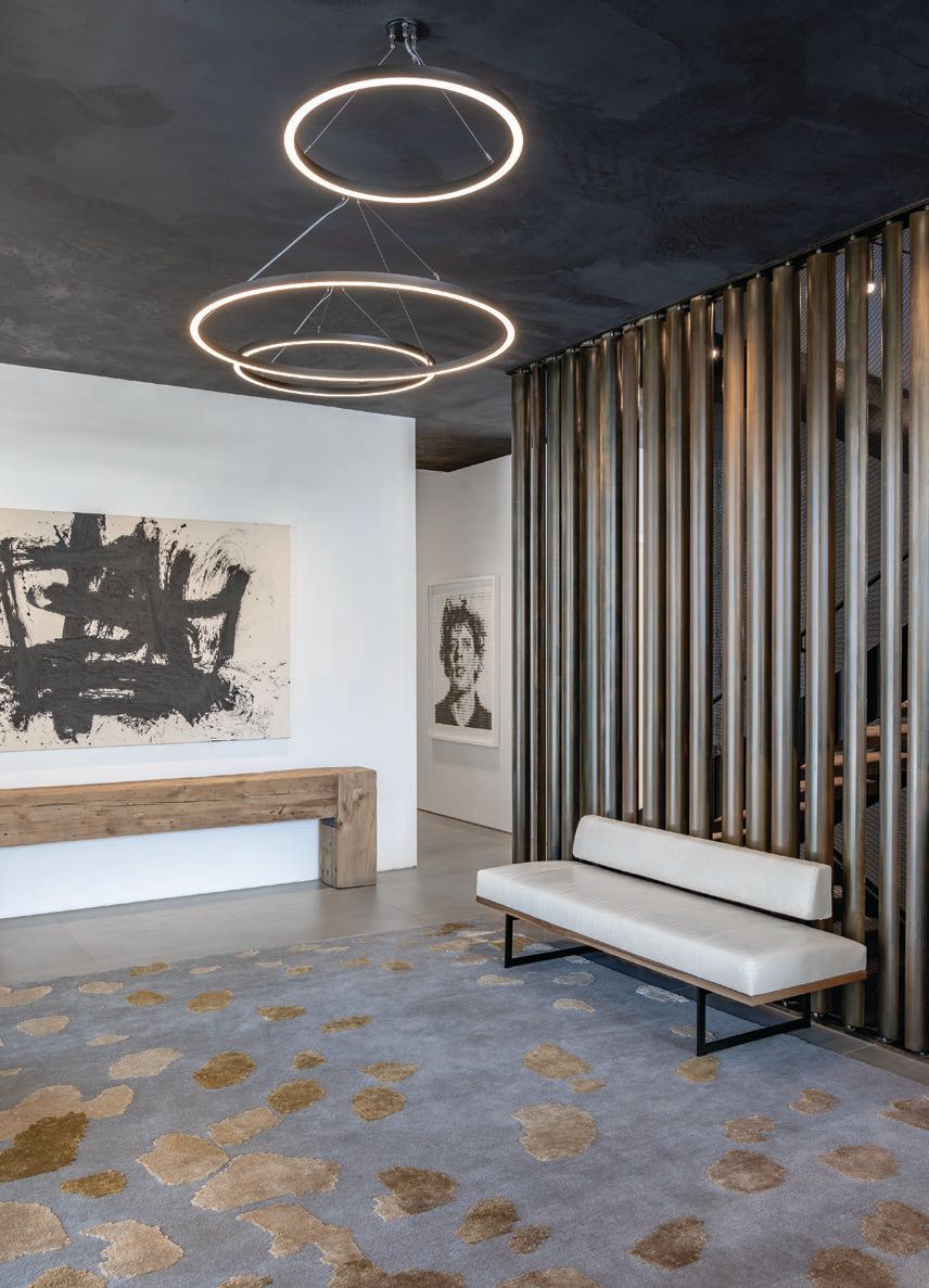 The foyer features a custom metal kinetic screen designed and created by Berg’s brother, sculptor and artist Tom Queoff , and artworks by Santiago Parra and Chuck Close PHOTOGRAPHED BY DRAPER WHITE