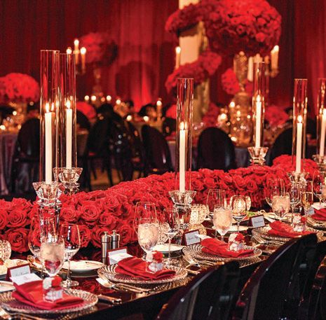 A serpentine 12-foot garland of red roses adorned the head table