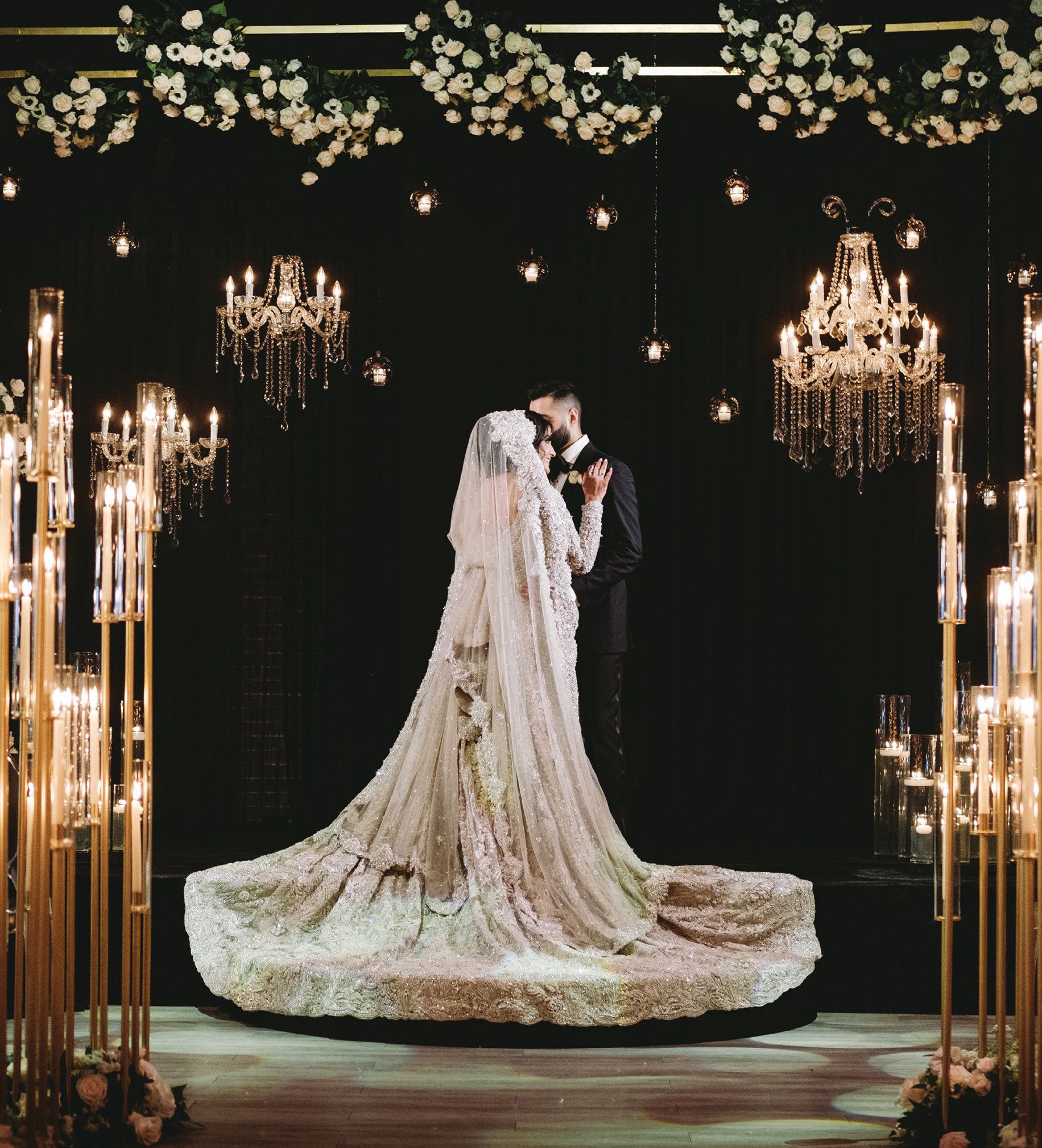 Chandeliers seemed to float in midair against black draping. Photographed by Zandbox Photo