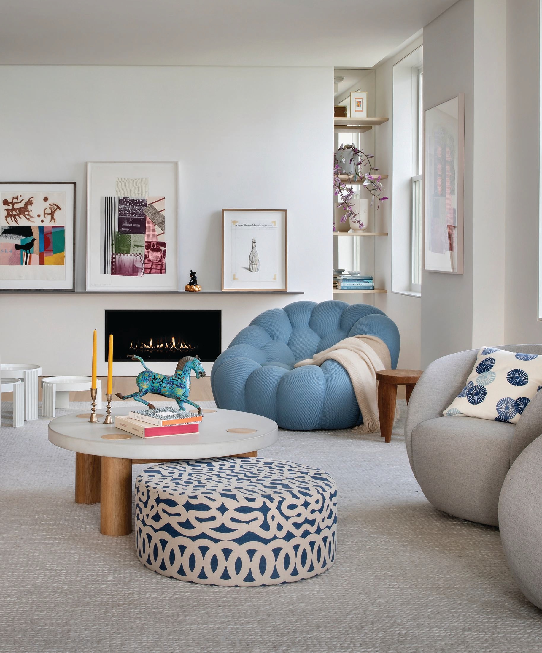 The living room pops with Roche Bobois’ Bubble pivoting armchair upholstered in Marina 2014 Techno 2D, a custom concrete-topped coffee table by Greyscape Studio, and a custom ottoman by Rooster Socks Furniture upholstered in indigo unbleached linen by Raoul Textiles, plus art pieces from the clients’ collection. Photographed by Gibeon Photography