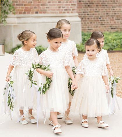 Flower girls carried round bouquets. Photographed by Olivia Leigh Photographie