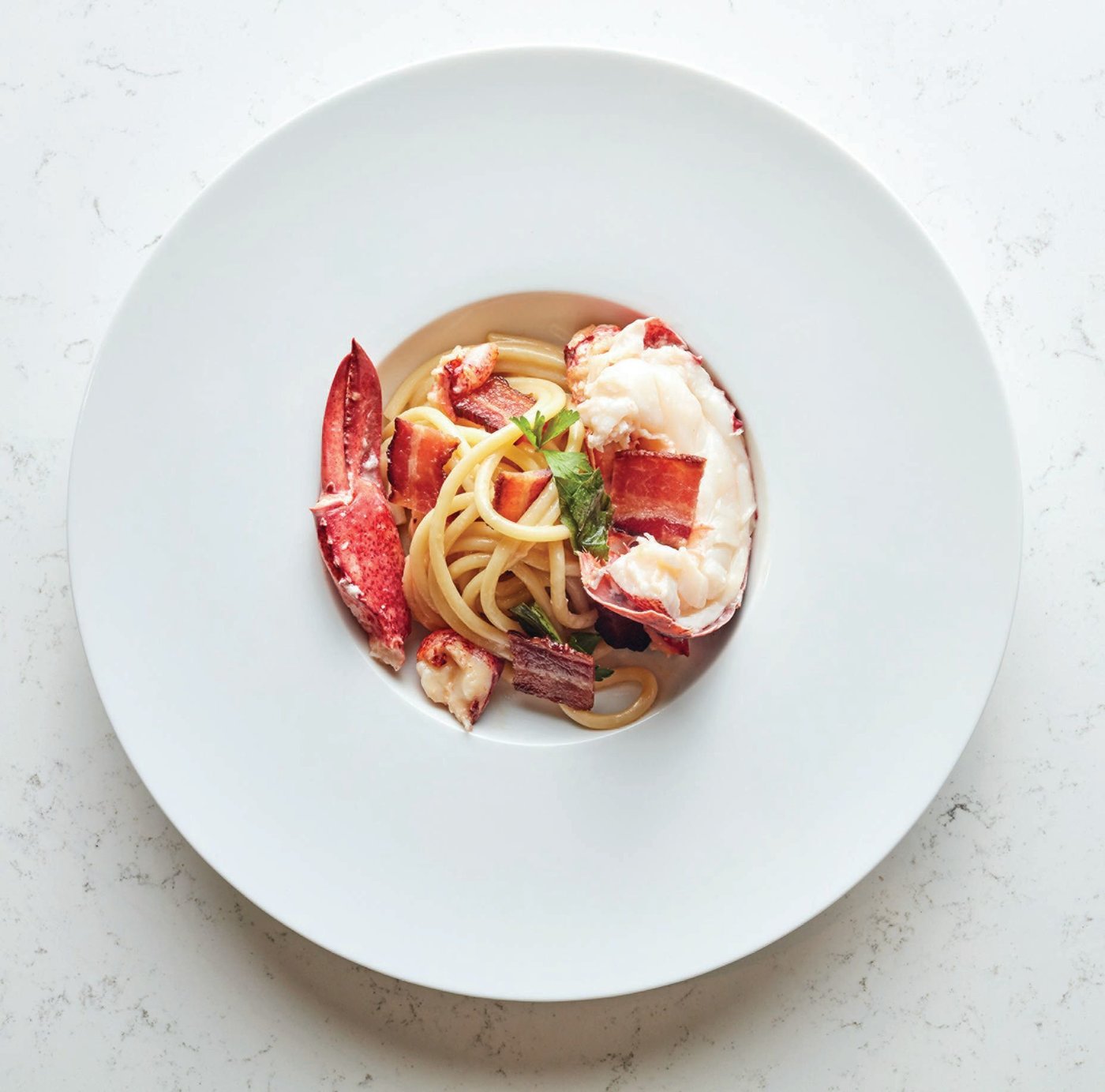 Adorn’s lobster and spaghetti “Joe Beef” style celebrates one of Montreal’s great restaurants—as well as, notes chef Jonathon Sawyer, “East Coast freezing-cold water, Canadian lobsters, great bucatini and just a little bit of cognac and cream for good luck.” PHOTO BY HAAS AND HAAS PHOTOGRAPHY