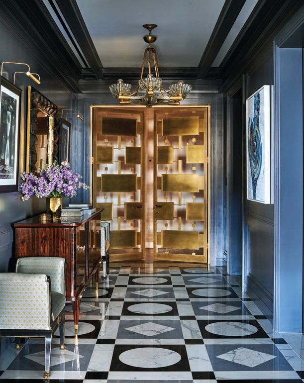 With Calacatta Vena Oro and Pietra Grigio marble tile, a 1940 art deco brass mounted Murano glass chandelier by Ercole Barovier, Soucie Horner custom-designed doors produced Bader Art Metal, and walls in Benjamin Moore's Cheating Heart, the elevator lobby is a stunner. Photographed by Richard Powers
