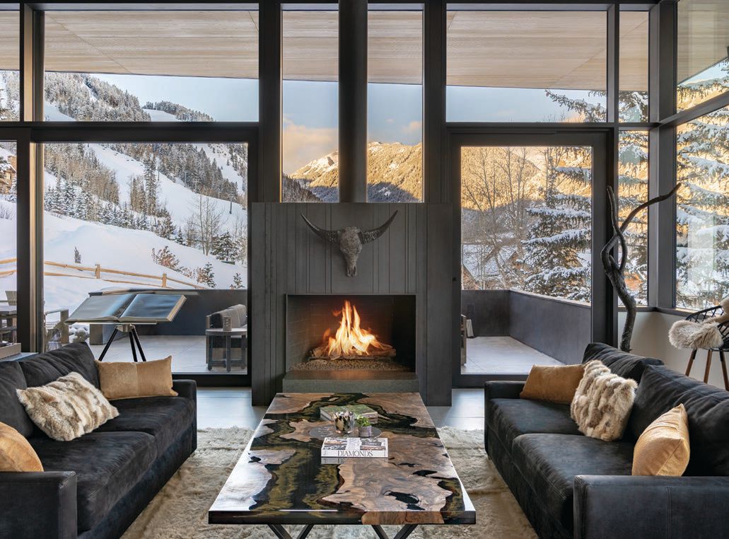 A custom coffee table pairs with RH sofas in the main living area, which offers scenic views of the nearby slopes and mountains PHOTOGRAPHED BY DRAPER WHITE