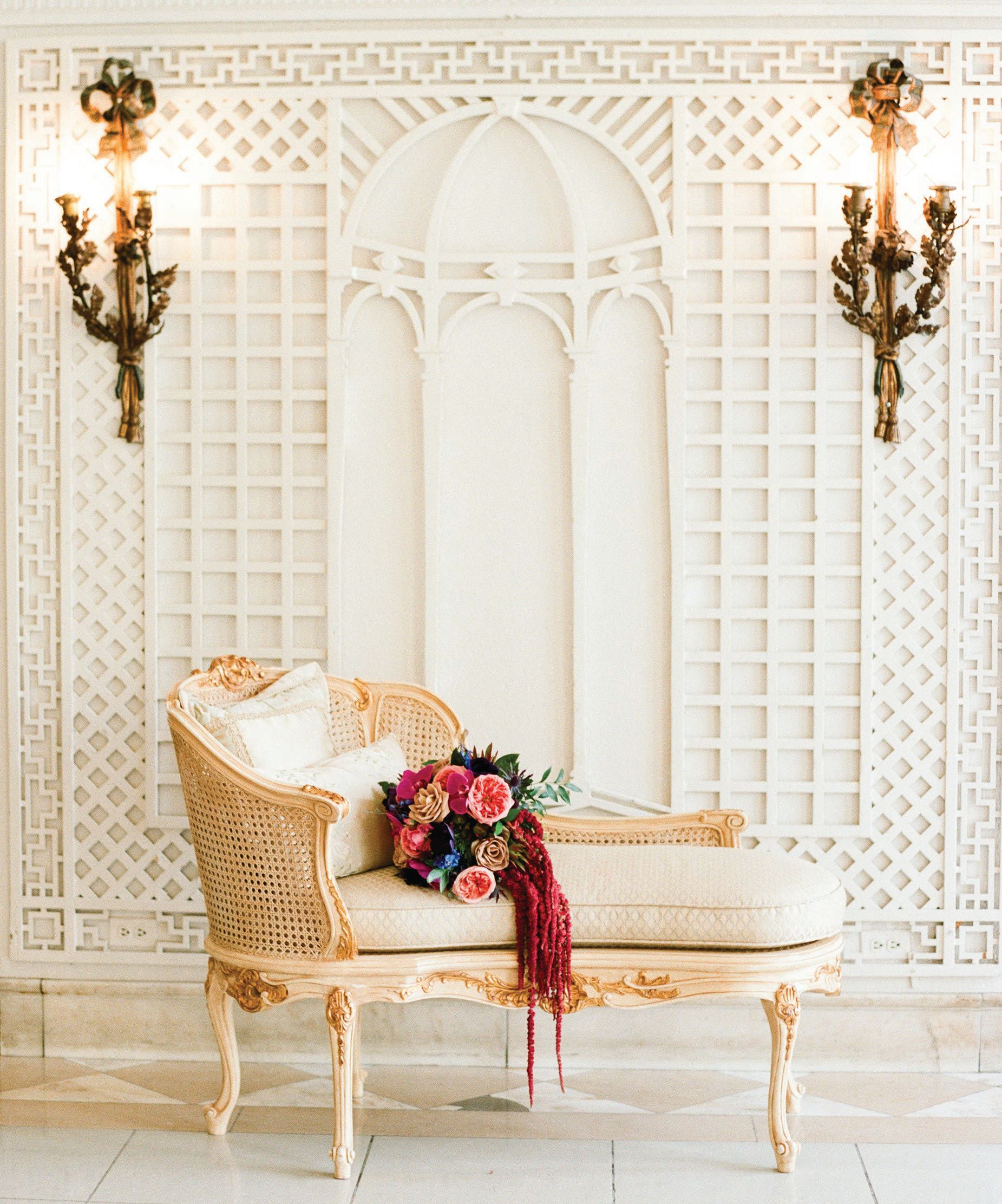 The Gilded Aisle team provided an antique chaise lounge to play up the French influence. Photographed by Lisa Blume Photography & Lynette Boyle Photography
