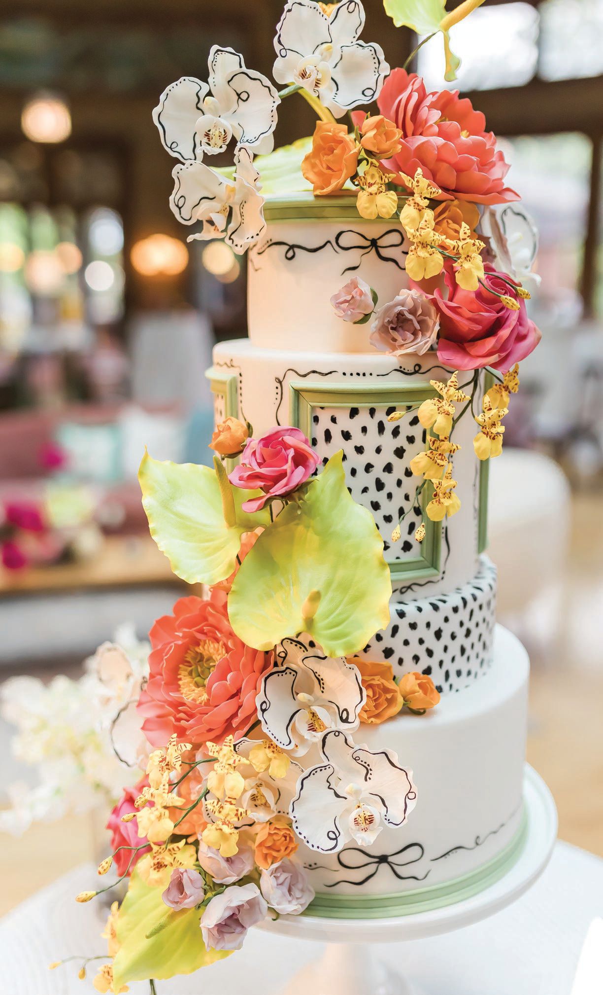 Cake Design crafted a whimsical confection with different flavor combinations in each of the four tiers PHOTO BY NATALIE PROBST PHOTOGRAPHY