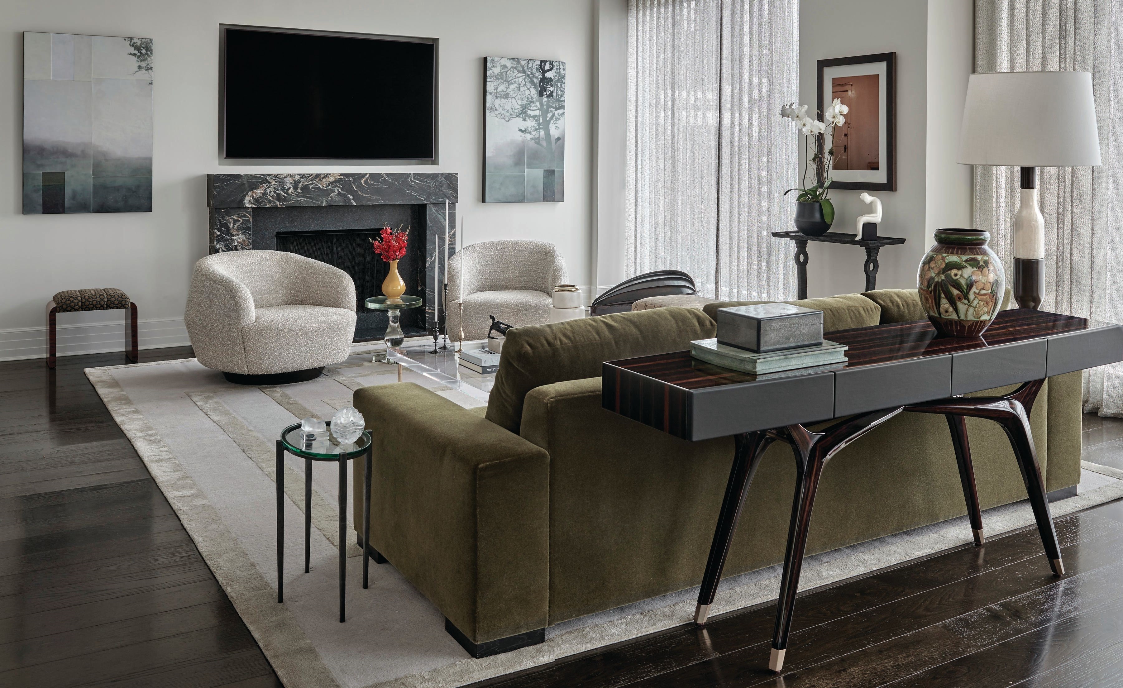 In the living room, a sofa by Yung Atelier upholstered in Pierre Frey mohair in Bold Army and a pair of Sumo armchairs by Holly Hunt in Métaphores Toundra Sable fabric draw immediate attention.  PHOTOGRAPHED BY TONY SOLURI