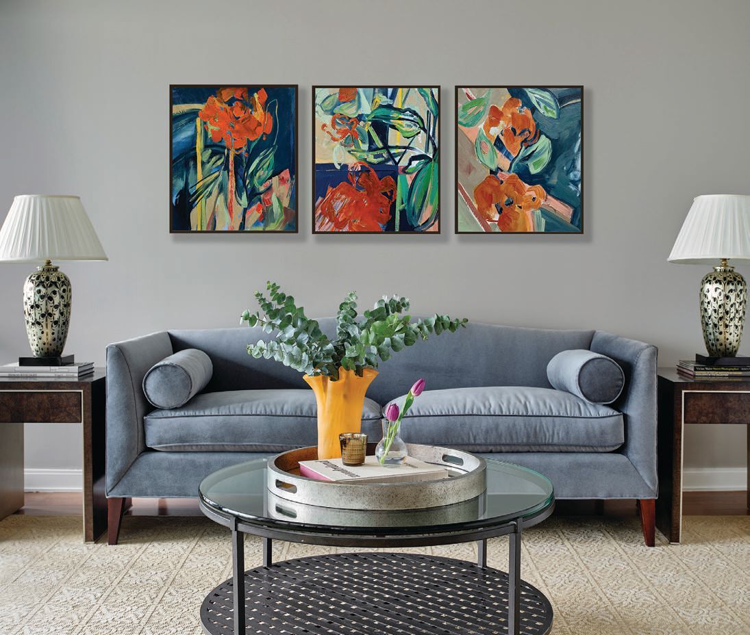 The living room draws the eye with a series of three artworks by Pamela Staker along with a Camelback sofa by Baker Furniture upholstered in slate Calico Corners luster velvet performance fabric PHOTOGRAPHED BY Gynthia Lynn