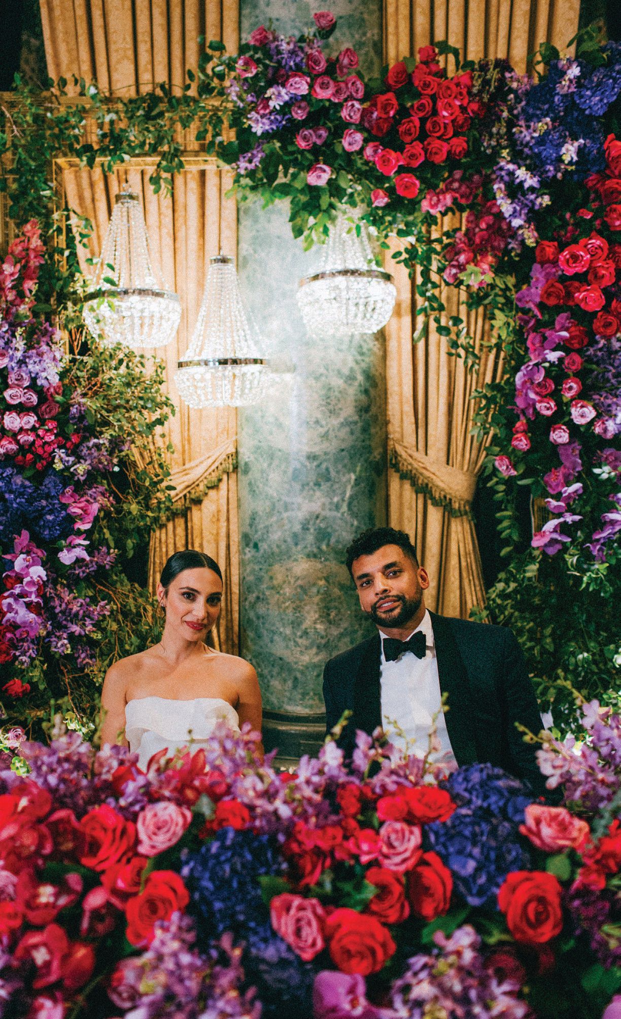 Roma and Umar gave off royal-wedding vibes posing for a portrait among their majestic florals. Photographed by Caroline Ghetes