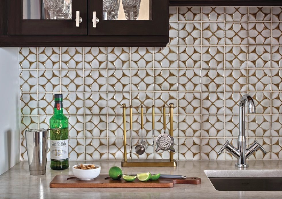 The den wet bar has pizzazz of its own with Schumacher’s Herringbone Paperweave black wallpaper, custom shelving by -ism Furniture and Nero Mist granite countertops by MSI Surfaces. PHOTOGRAPHED BY Gynthia Lynn