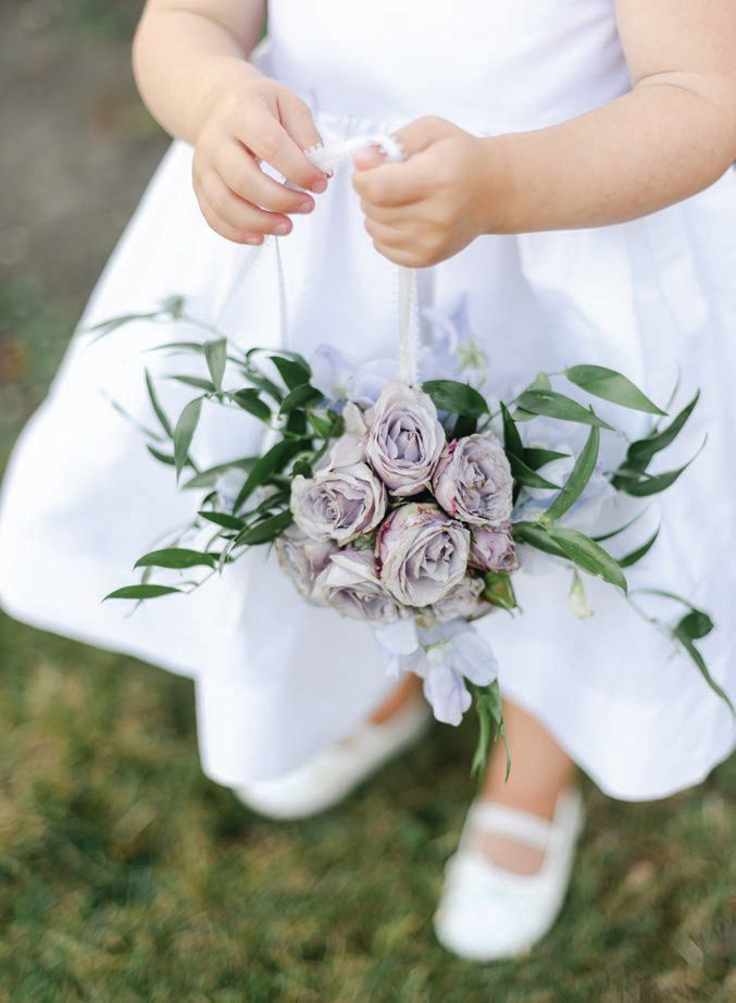 Flower girls wore special occasion dresses by Susanne Lively and carried mini bouquets on a string Photographed by Averyhouse