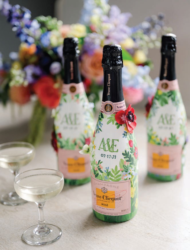 The couple’s monogram featured on mini Champagne bottles Photographed by Liz Banfield