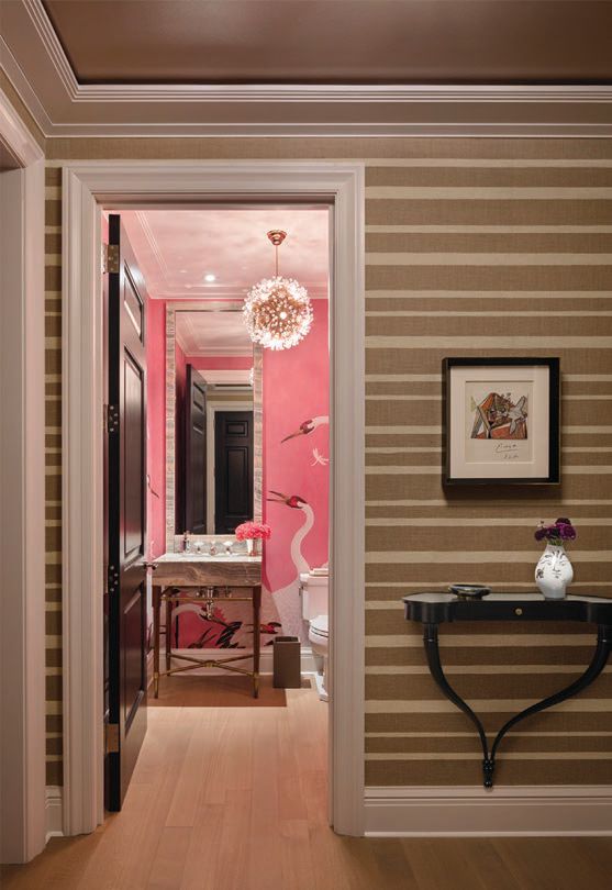 The powder room pops with Gucci Heron print wallpaper and a vintage Austrian 1950s crystal chandelier by Emil Stejnar for Rupert Nikoll PHOTO BY SCOTT FRANCES/COURTESY OF RELATED MIDWEST