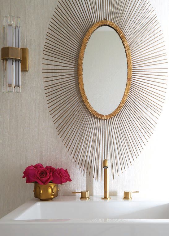 A striking Regina Andrew mirror hangs over Omexco wallpaper in the powder room PHOTOGRAPHED BY MICHAEL ALAN KASKEL 
