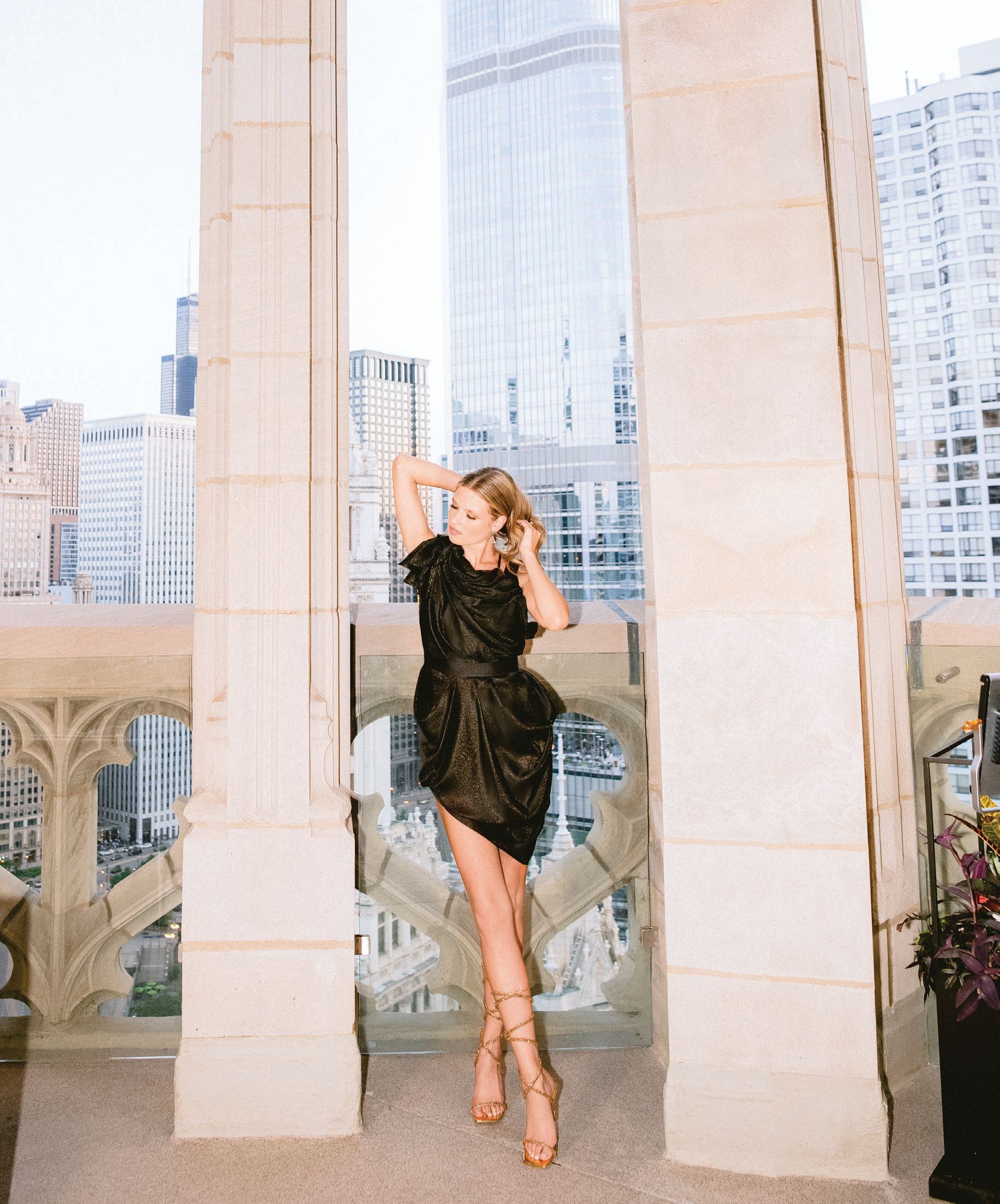 Black double-faced silk charmeuse with gold fleck asymmetrically draped minidress, featuring a crisscross ribbon open back. PHOTO BY LISA BLUME