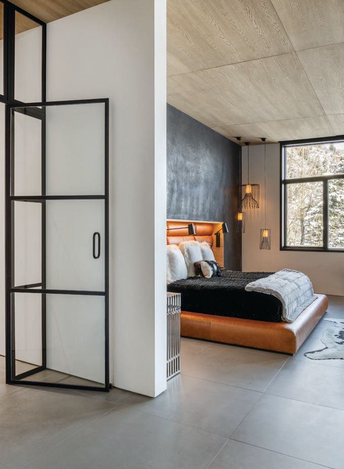 In the primary bedroom suite, a custom bed and closet by the design team await. PHOTOGRAPHED BY DRAPER WHITE