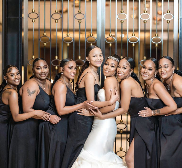 Lanita’s bridal party donned black satin one-shoulder dresses with a high slit Photographed by Imagery by Jules Photography