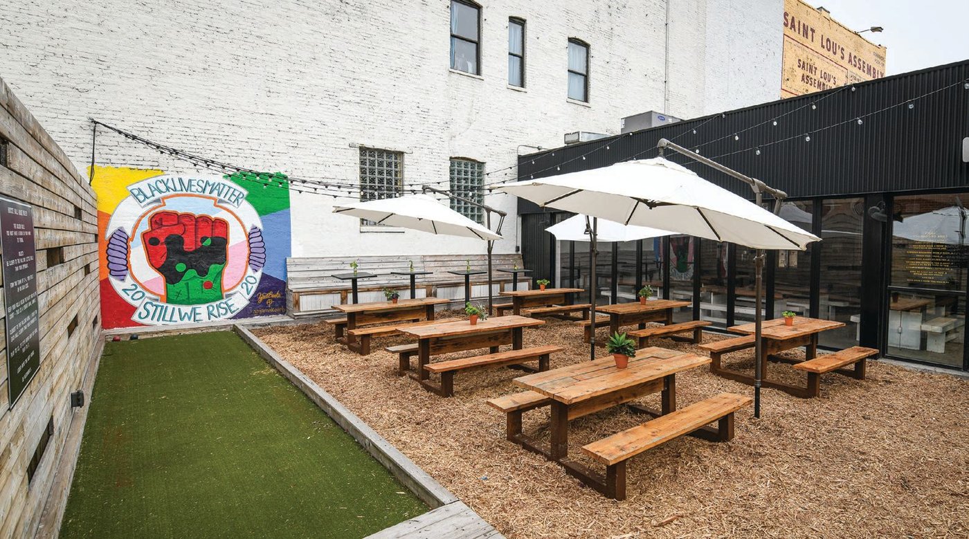 Complete with a bocce court and shaded picnic tables, the backyard patio is an ideal respite from the industrial grit of Lake Street, just steps away. PHOTO BY LORENZO TASSONE