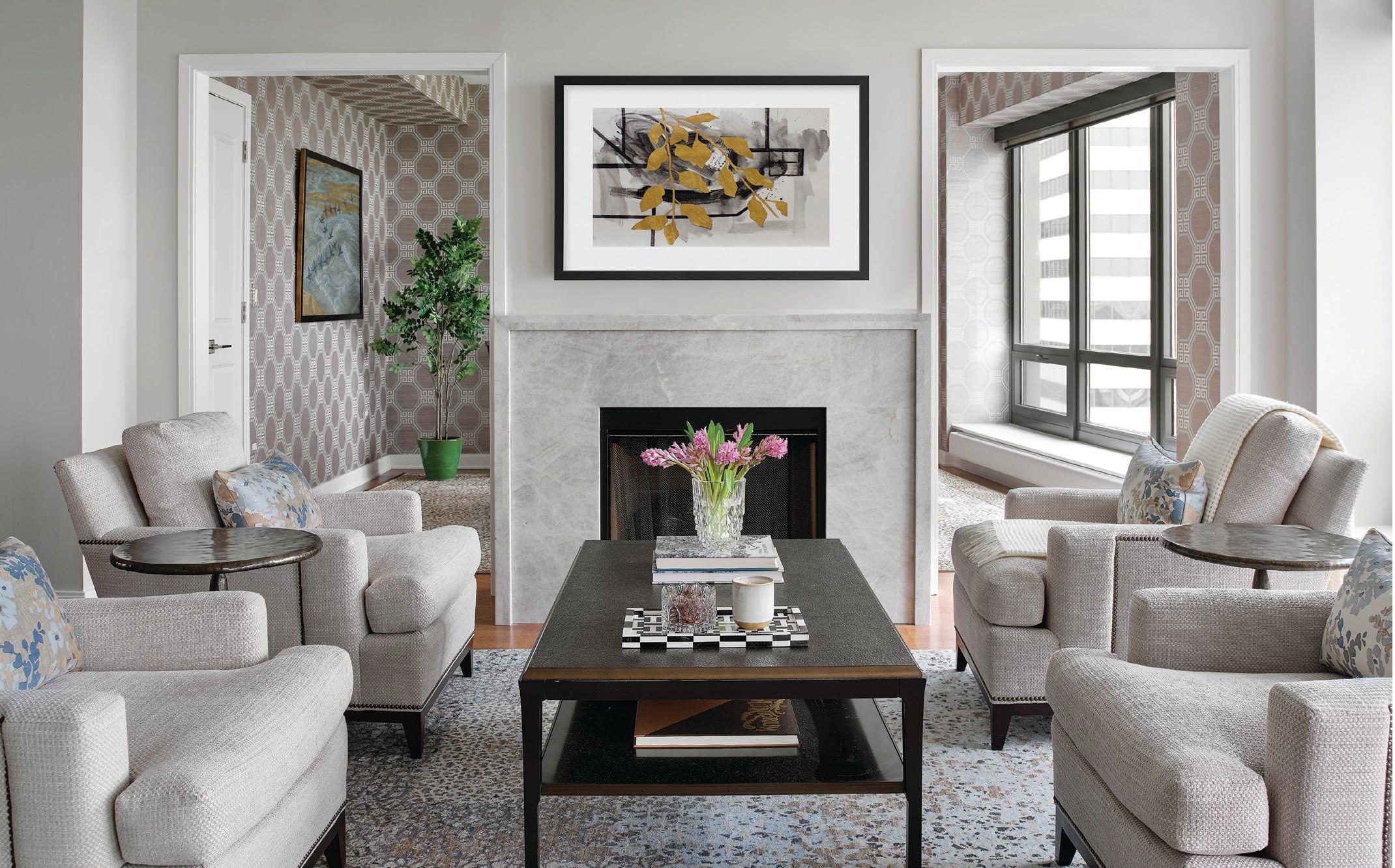 A quartet of 9th Street chairs by Hickory Chairs in fabric by Calico Corners sets a chicly neutral vibe in the living room, which also features a fireplace surround custom-designed and fabricated by Tamazula Granite in Taj Mahal quartzite from MSI Surfaces PHOTOGRAPHED BY Gynthia Lynn