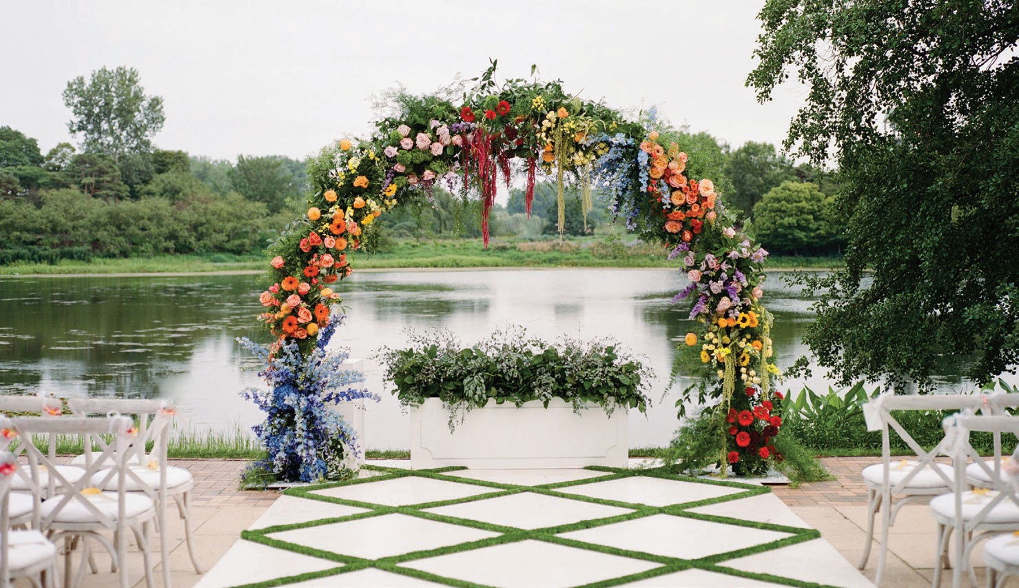 The ceremony setup featured a rainbow floral arch dreamt up by Jessica Griffin Pfluegl at HMR Designs. Photographed by Liz Banfield