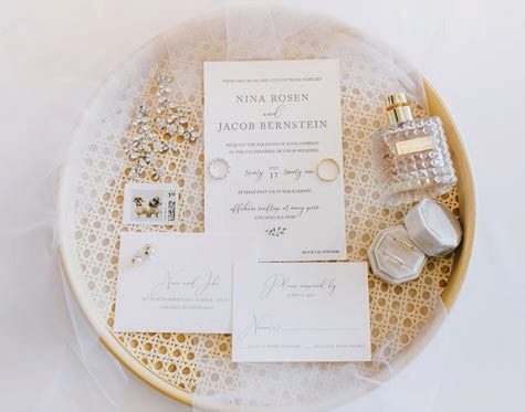 Their minimalist invitation suite featured gray print on light beige paper—and “the envelopes were addressed with personalized stamps featuring our dogs in bow ties,” Nina says.Photographed by Connie Marina Photography
