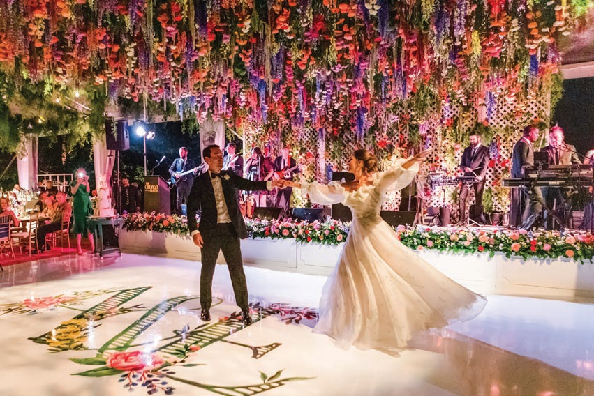 Hanging florals created a magical moment for the newlyweds’ first dance Photographed by Liz Banfield