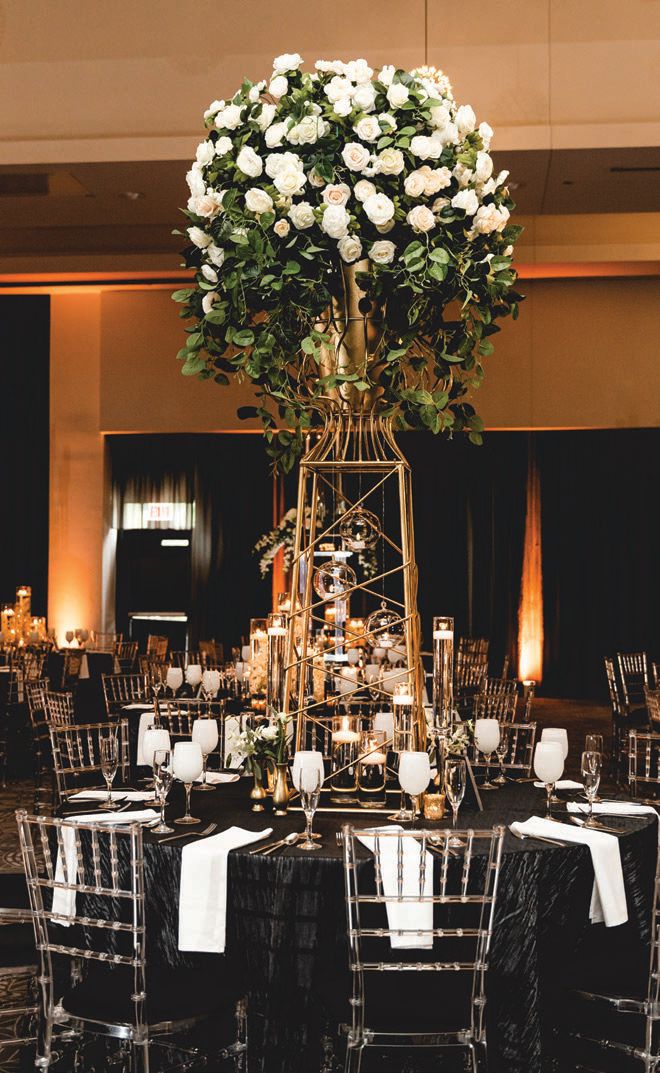 Tables were topped with towering centerpieces Photographed by Soda Fountain Photography