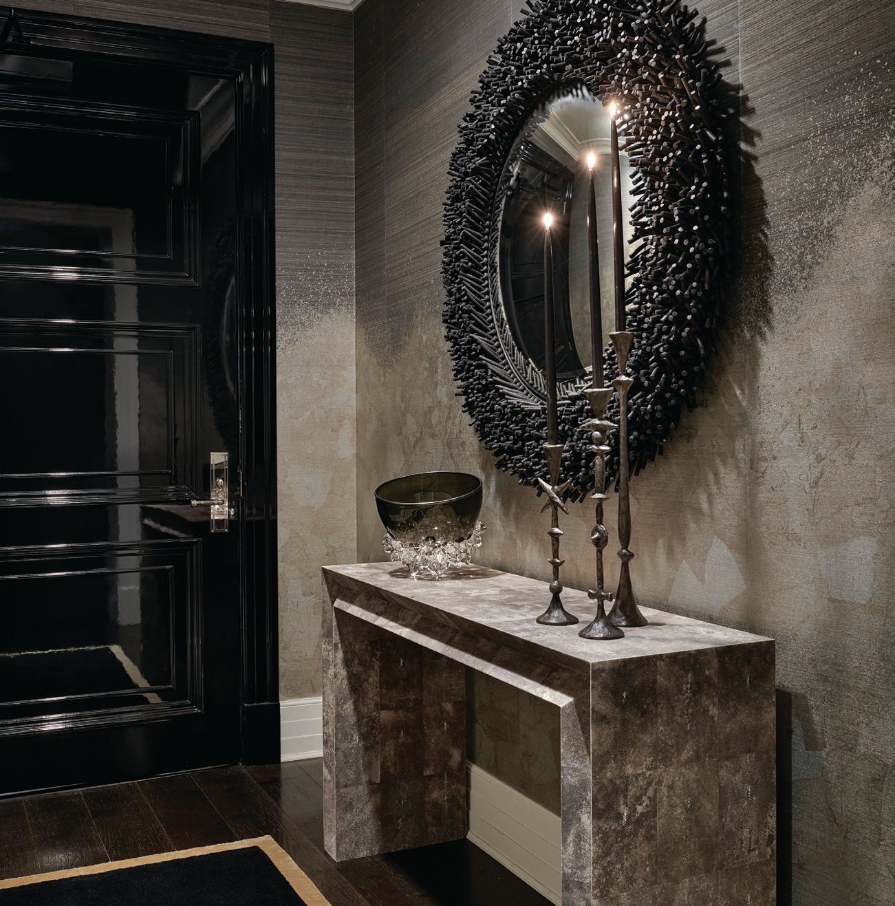 A black lacquer door, Phillip Jeffries Metallic Ombre wallpaper in Pewter on Shetland horsehair, and a Christian Astuguevieille black rope mirror add up
to a seriously dramatic foyer.  PHOTOGRAPHED BY TONY SOLURI