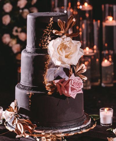 The black fondant cake was decorated with gold flakes and lush roses and embellished with gilded greenery Photographed by Zandbox Photo