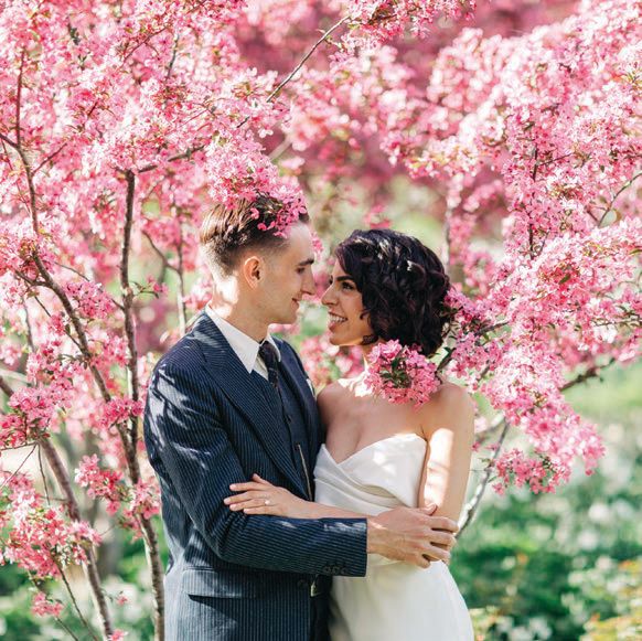  Real couple Kathryn and Joe posed near a blossoming tree at their wedding planned by LOLA Event Productions and photographed by Elena Bazini. PHOTO BY ELENA BAZINI